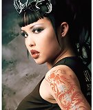 busty tattooed naked Eurasian girl wearing horns