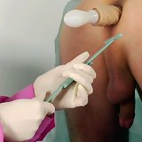 Dildoed ass of a femdom medical plaything